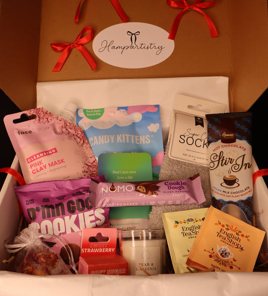 Hampartistry gift box with various items including a pink clay mask, candy kittens, and English Tea Shop tea bags.