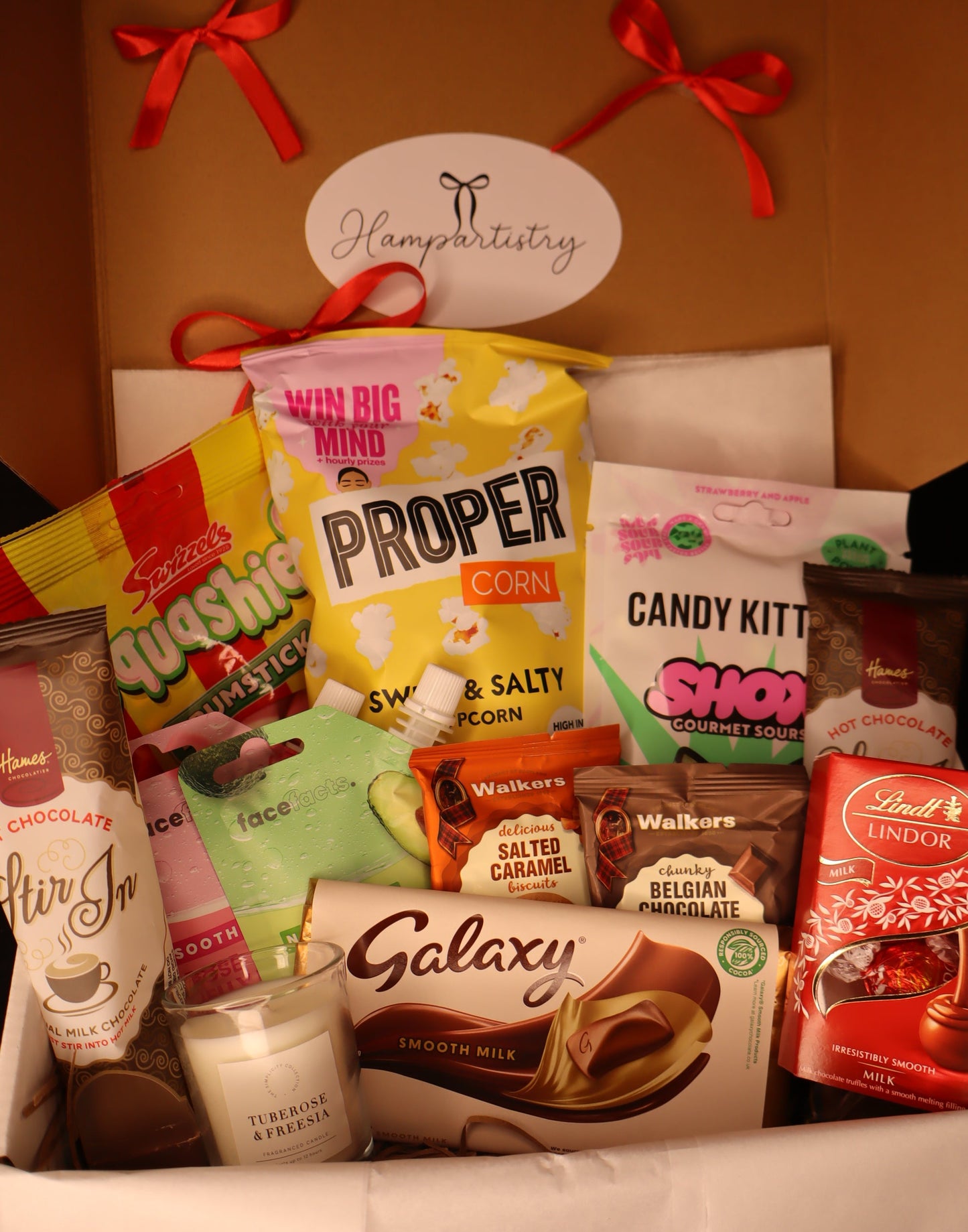 Assorted movie night treats in a box with a visible brand label.