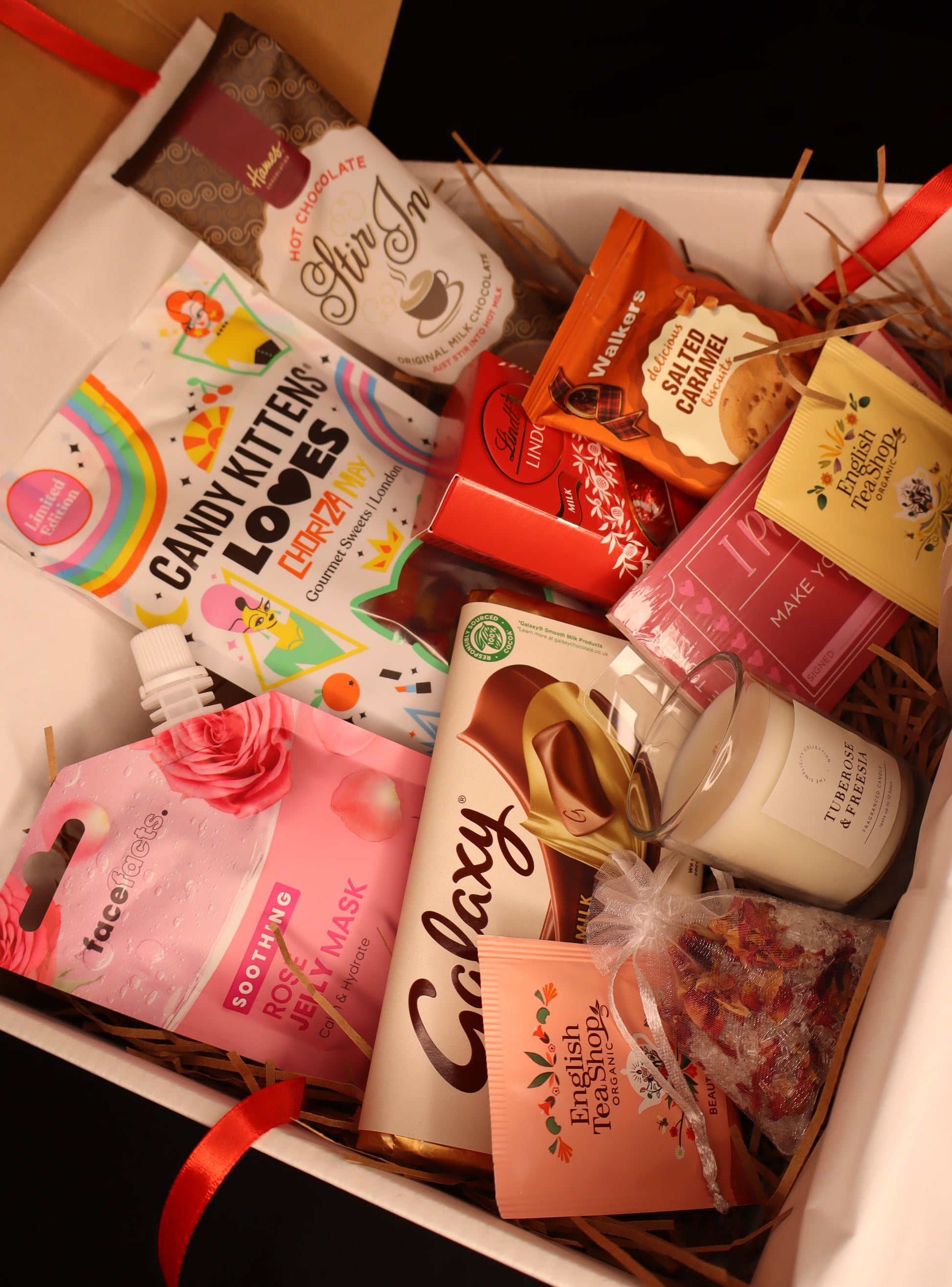 Assorted snacks and treats in a box with visible branding