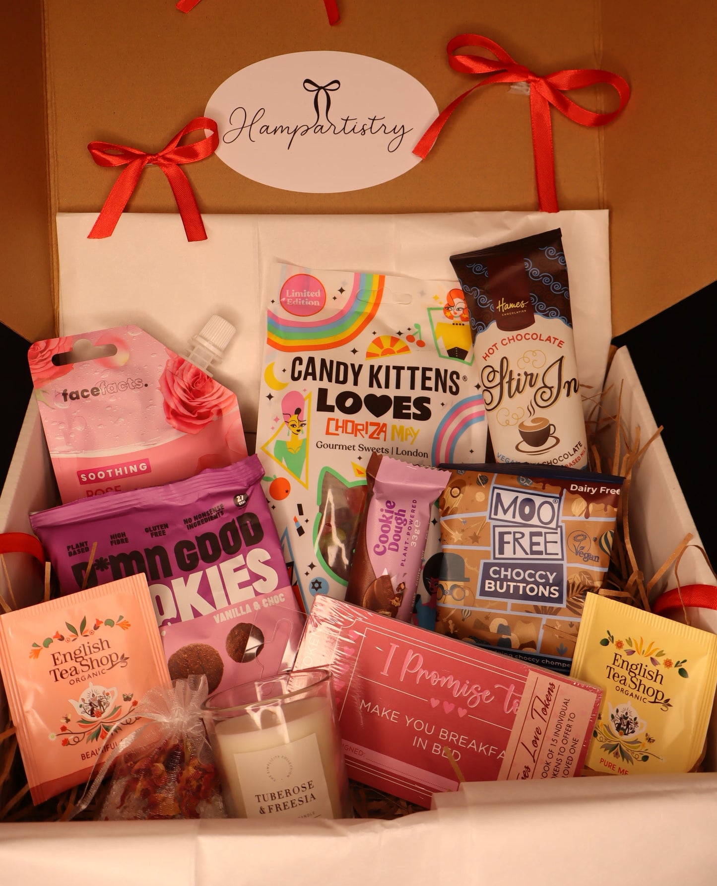 Gift box with various items including cookies, tea, and chocolate, branded 'Hampartistry'.
