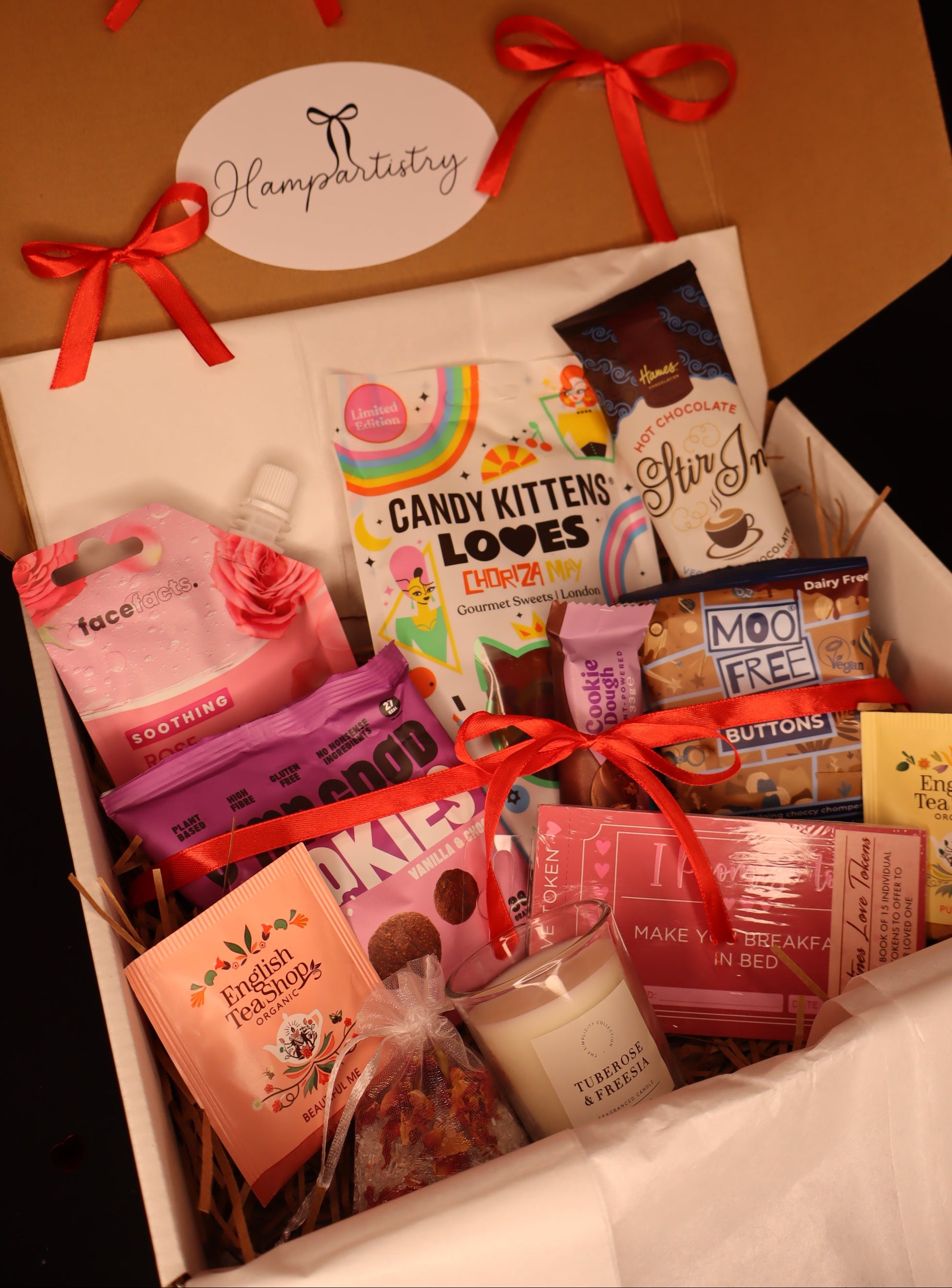 Gift box with various items including snacks and a candle, branded 'Hampartistry'.
