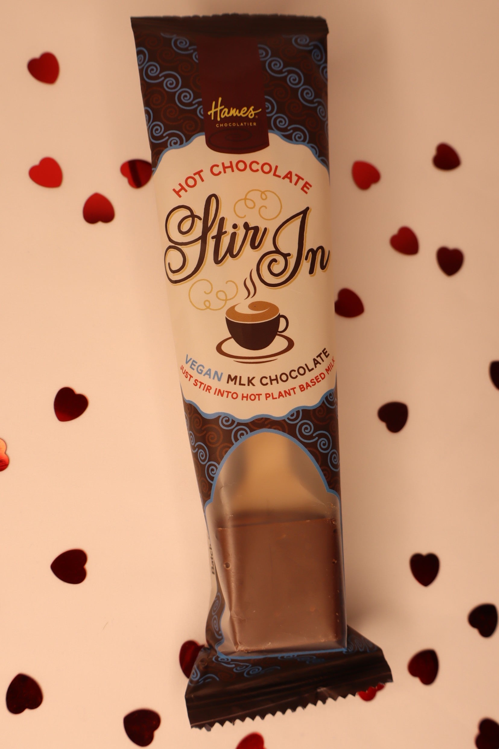 Hot chocolate stir-in packet with a heart patterned background