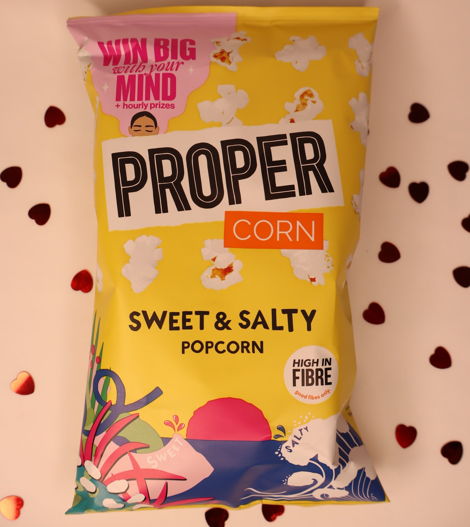 Yellow package of Proper Corn Sweet & Salty Popcorn with colorful graphics on a white background.