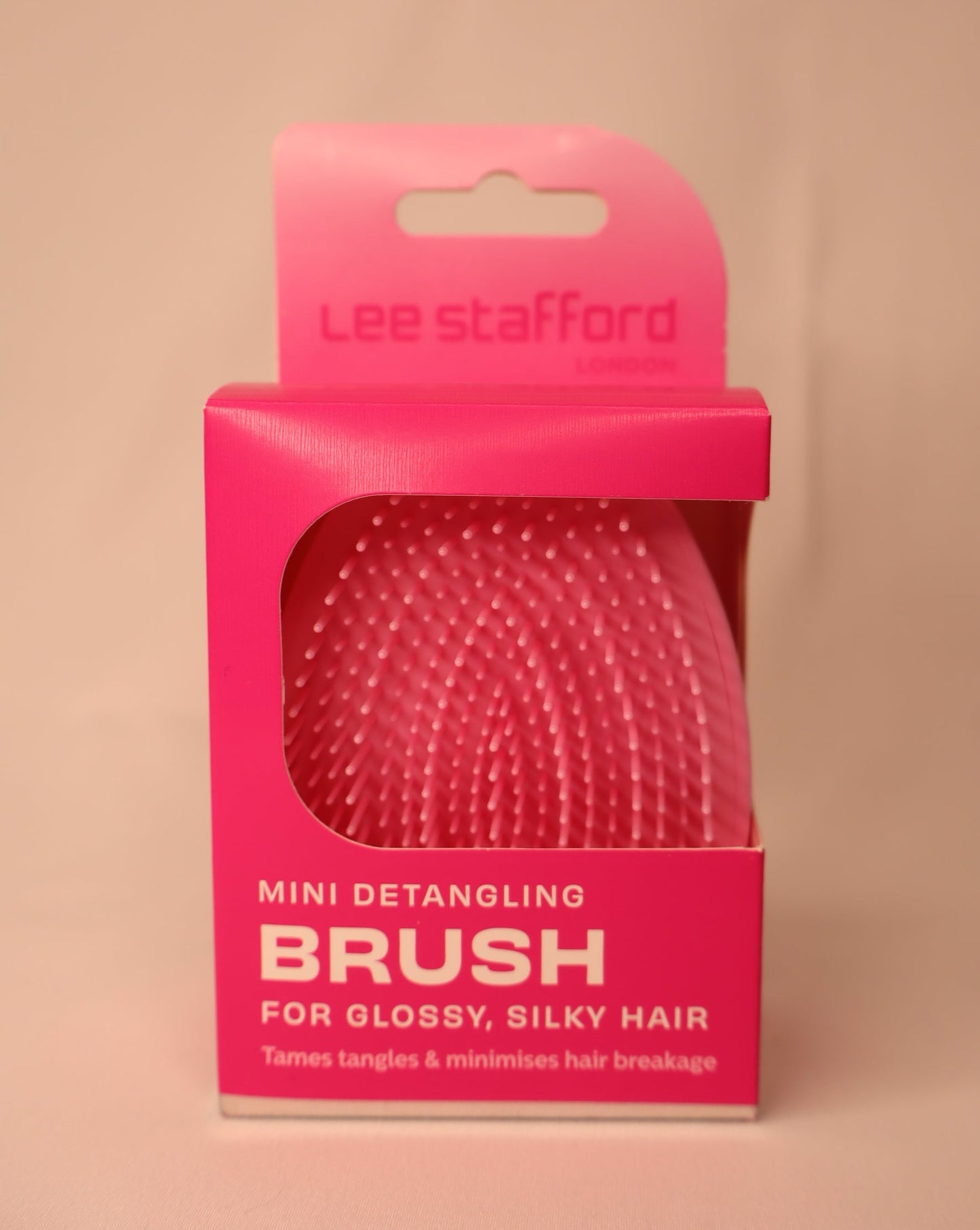 Pink detangling brush packaging with Lee Stafford branding on a white background