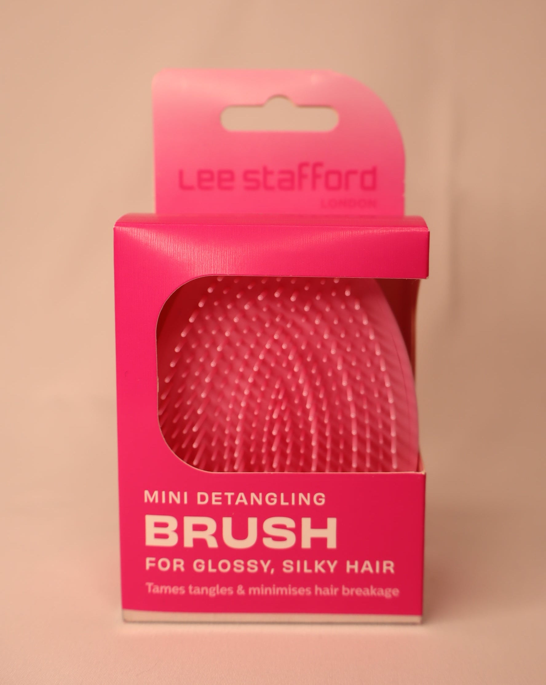 Pink detangling brush packaging with Lee Stafford branding on a white background