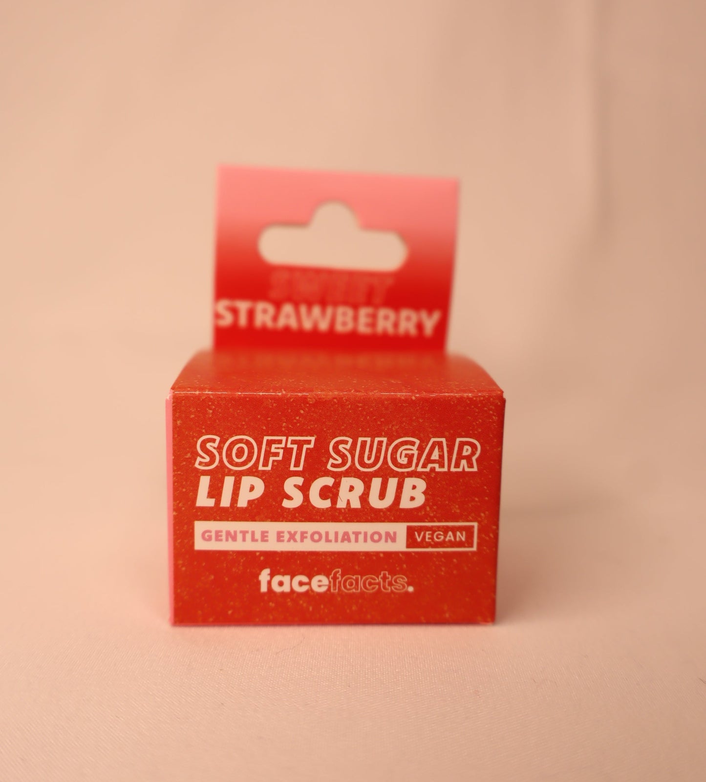 Red box of strawberry soft sugar lip scrub with 'face facts' branding on a white background