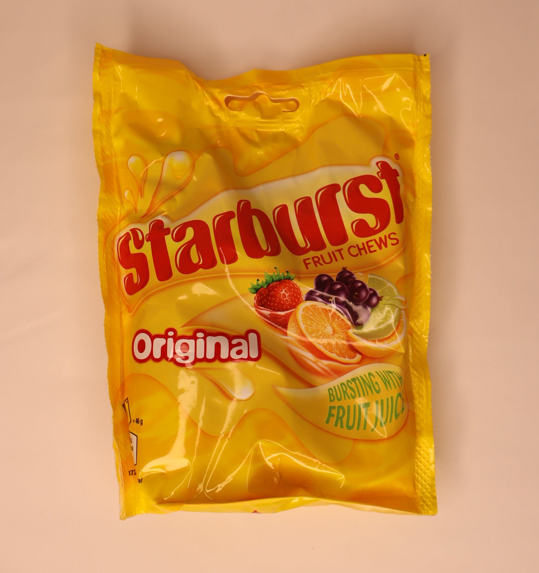Yellow packet of Starburst Original fruit chews on a white background