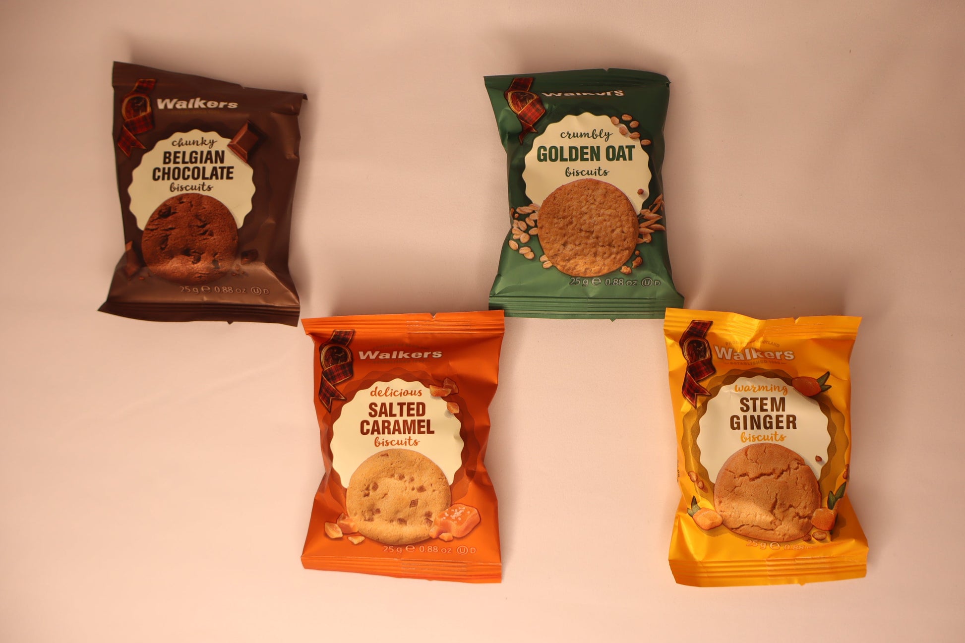 Four packages of Walkers biscuits on a white background