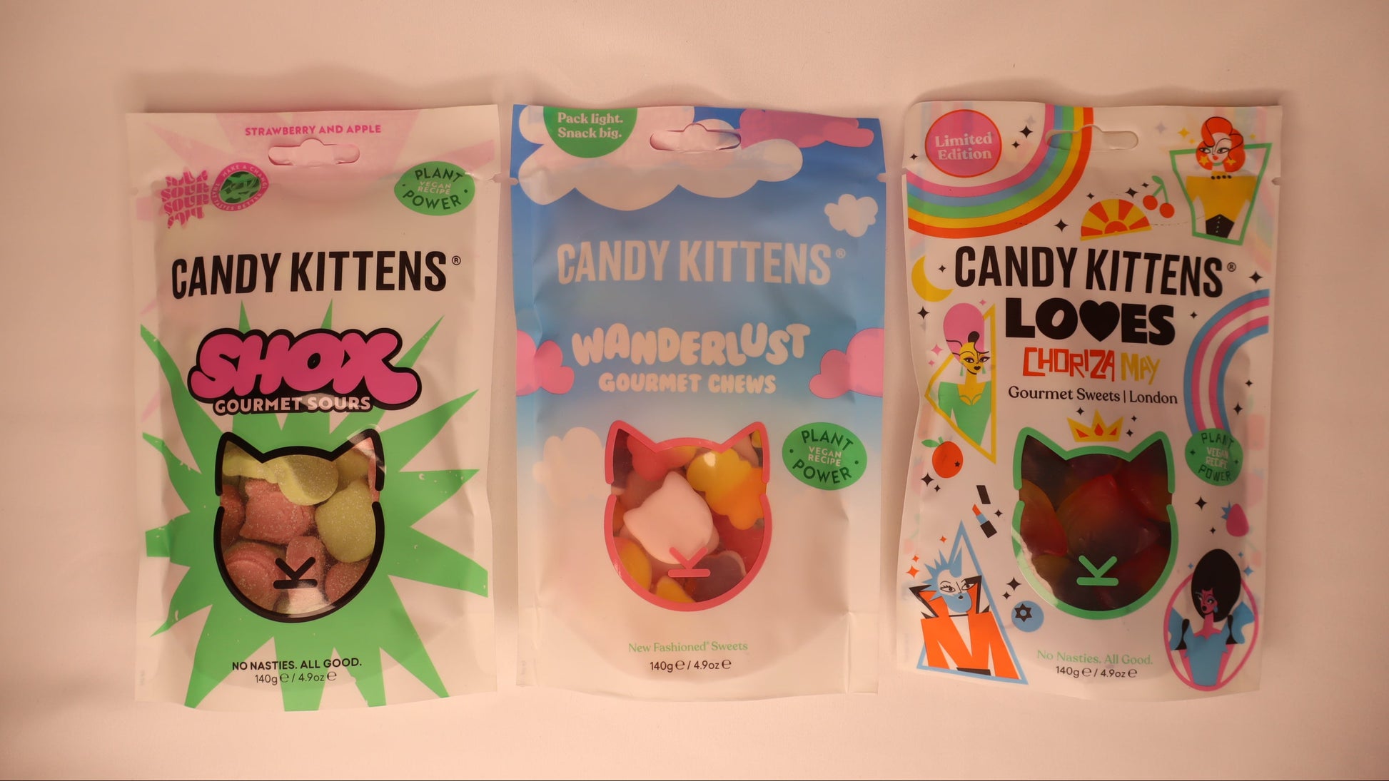 Three packages of Candy Kittens treats on a white background